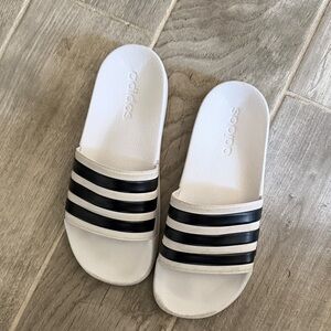 Adidas Black and White Striped Slides running like a 7